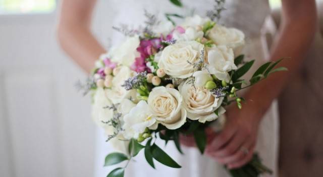 Wedding Flowers include bridal bouquets, bridesmaids bouquets, boutonnieres, corsages and flowers set up throughout.